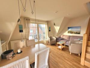 a living room with a table and a couch at Holiday apartment in Wyk with swimming pool in Wyk auf Föhr