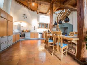 a large kitchen with a wooden table and chairs at Holiday home Mühle Catharina in Oldenswort