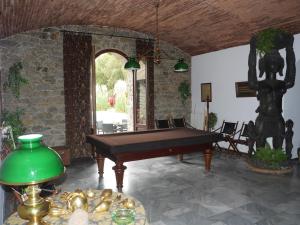 a pool table in a room with a stone wall at U Palazzu Corte in Corte