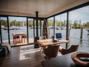 a home office with a table and a laptop on it at Floating Comfort in Peenemünde in Peenemünde