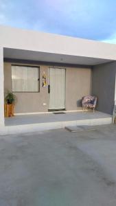 a building with a chair sitting in front of it at Vila Negreiros Serra Negra Casa 3 in Bezerros +1 photo