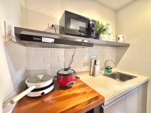 a kitchen counter with a microwave above a sink at Cebu Property Express in Cebu City