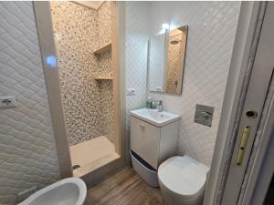 a bathroom with a toilet and a sink and a shower at Capri Aquarium Family in Capri