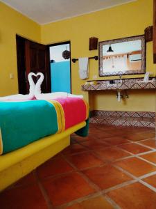 a hotel room with a bed and a mirror at Estrella - Casa MoJo's airy 2BR, kitchen, pool in Sayulita