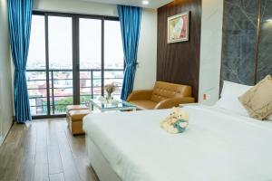 a hotel room with a teddy bear sitting on a bed at BRIO Hotels & Apartments in Da Nang
