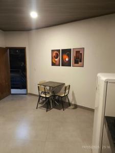 a dining room with a table and two chairs at Apto PROX Petrobrás Fiat Betim 5 in Betim +12 photos
