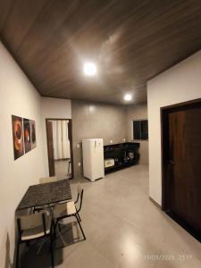 a living room with a table and a refrigerator at Apto PROX Petrobrás Fiat Betim 5 in Betim