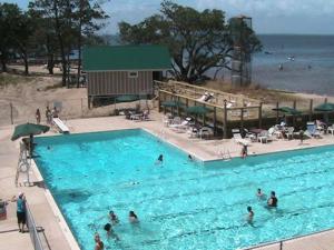 a group of people in a large swimming pool at Canal Front Boater's Paradise in Kill Devil Hills
