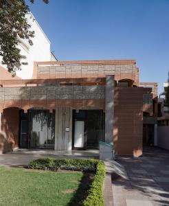 a large brick building with a grassy yard at city centre luxury villa in Jammu