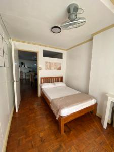 a bedroom with a bed and a dining room at LJ's Burnham Homestay in Baguio +21 photos