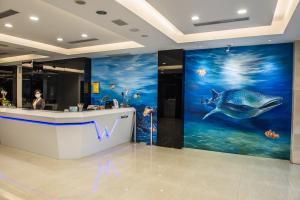 a lobby with a shark mural on the wall at Wecan Hotel in Kaohsiung