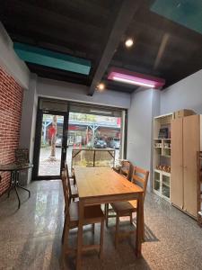 a dining room with a wooden table and chairs at Miaoli Sanyi Travelling Homestay in Sanyi
