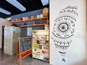 a wall with a drawing on the side of a room at Miaoli Sanyi Travelling Homestay in Sanyi