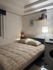 a bedroom with a large bed in a room with a lamp at Moneystay Daegu Palgongsan in Daegu
