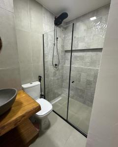 ein Badezimmer mit Dusche, Toilette und Waschbecken in der Unterkunft Suíte Mar - Vila dos Pescadores Condomínio Portogalo in Angra dos Reis