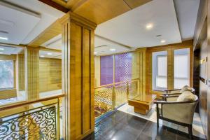 a room with a balcony with chairs and a table at Super Townhouse Oak JVH Hotel Bangalore in Bengaluru