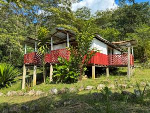 a house with a red and white roof at Pueblo Chiquito in Inderena +22 photos