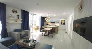 a living room with a couch and a table at Oceanami Villas Resort Beach in Long Hai