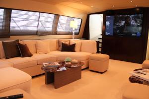 a living room with a couch and a tv at 105 ft Yacht in Mikonos