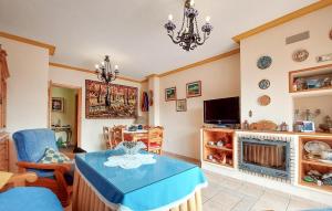 a living room with a table and a fireplace at 5 Bedroom Cozy Home In El Portil in El Portil