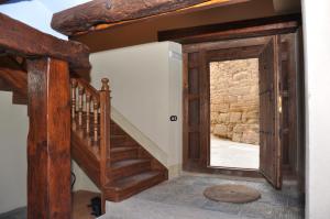 an open door leading to a staircase in a house at Apartamentos Turismo Rural Casa Purroy in El Grado