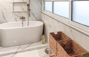 a white bathroom with a sink and a window at Cozy Apartment In Supetar in Supetar