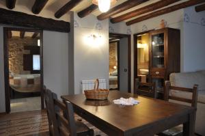a dining room with a wooden table and chairs at Apartamentos Turismo Rural Casa Purroy in El Grado