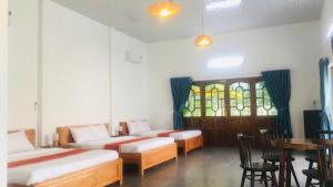 a room with two beds and a table and chairs at My Anh Garden in Ấp Thiẹn Ái +60 photos
