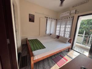 a bedroom with a bed in a room with a window at Hornbill inn in Cochin