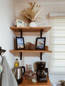 a kitchen counter with wooden shelves on the wall at Estudio CB in La Paz