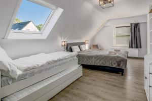 a bedroom with two beds and a window at Villa In Oostduinkerke in Koksijde