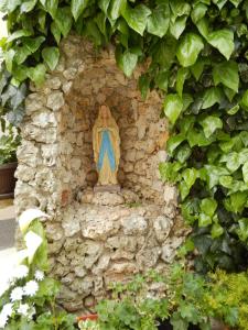 a statue of a virgin sitting on a stone wall at Apartments Hortensia in Pula