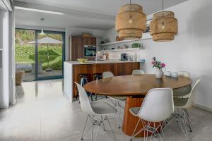 a kitchen and dining room with a wooden table and chairs at Juliette V4 P in Oostduinkerke +18 photos