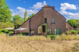 a large brick house with a green door at Juliette V4 P in Oostduinkerke