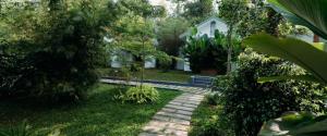 a garden with a stone path in front of a house at Le Vista Resort in Sultan Bathery