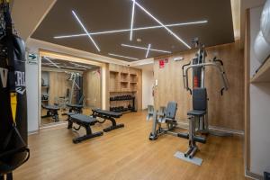 a gym with treadmills and exercise equipment in a room at Alta Apartments by Geko in Lima