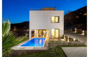 a house with a swimming pool in front of it at Casa Fani in Poljane +40 photos