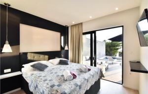 a bedroom with a large bed and a balcony at Stunning Home In Makarska With Wifi in Makarska