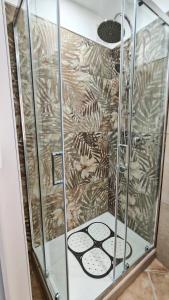 a shower with a glass door with a shower seat at Da Nenè in Cefalù +27 photos
