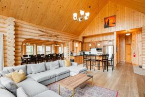 a living room and kitchen with a couch and a table at Fiddler Lake Resort - Elk 96 in Mille-Isles +36 photos