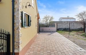 a brick walkway next to a building with a gate at 4 Bedroom Stunning Home In Vodice in Vodice