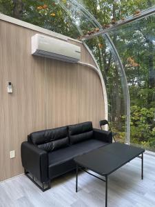 a black couch and a table in a room at 2-bedroom Capsule House #30 in Parry Sound +21 photos