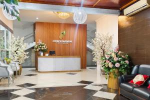 een lobby met een receptie en bloemen bij RedDoorz near Focal Point Medan in Sunggal