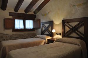 Ein Bett oder Betten in einem Zimmer der Unterkunft Apartamentos Turismo Rural Casa Purroy