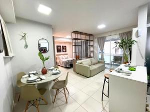 a kitchen and living room with a table and chairs at Loft que parece SPA em Belém in Belém