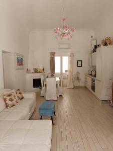 a living room with a white couch and a table at Love in Blue - La Terrazza di Positano in Positano