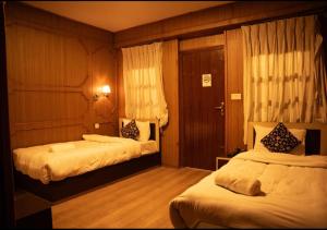 Postel nebo postele na pokoji v ubytování Nag Pukhu Guest House