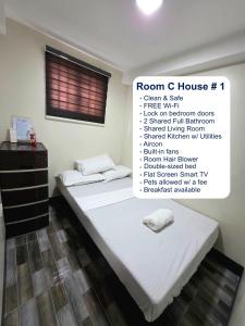 a room with two beds and a sign that says room c house at Mamadear's Bed & Breakfast in Suizo