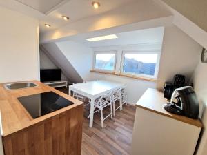 a small room with a kitchen and a table at Superior Duplex Apartment - nur 5 min vom Europa-Park in Rheinhausen