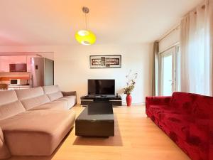 a living room with a couch and a tv at City center Luxury Apartment in Tirana
